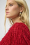 Close up of the Novelty Fringe Boxy Top style 254105 from Joseph Ribkoff in the color red