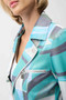 Close up of the Foiled Faux Suede Geometric Print Fitted Jacket style 261911 from Joseph Ribkoff in the colors green/multi