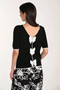 Back of the Reversible Bow Knit Top style 266525 from Frank Lyman in the colors black and off white