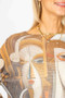 Close up of the Face Printed Batwing Sweater style 0930 from Look Mode in the color rust