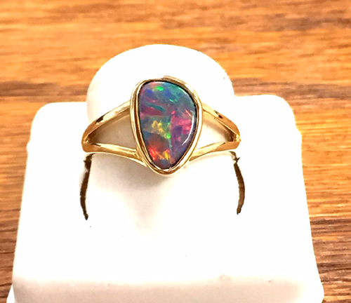 Black opal doublet set in 14K yellow gold ring.