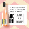 Kolonne Null Rosé poured in a wine glass at a fine-dining table — alcohol-free still rosé wine