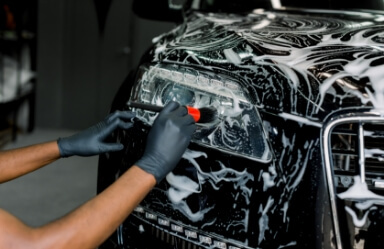 A car owner details the outside of his car with a car detail kit.