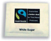 Fair Trade White Sugar Sachets Pk1000, image showing a packet of individual white sugar sachets with Fair Trade logo and branding.