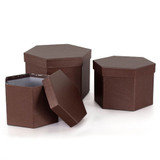A set of 3 hexagon shaped hat boxes in a brick brown colour, manufactured by Oasis.