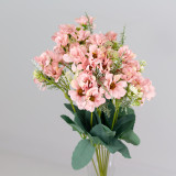 An artificial bunch of dusty pink daisies.