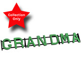 A floral foam display, spelling out the word 'GRANDMA', manufactured by Oasis.