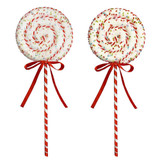 Two swirl lollipop decorations with sprinkles on them.