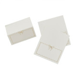 A pack of 8 White & Gold Wavy Edge Bow Place Cards, manufactured by Hootyballoo.