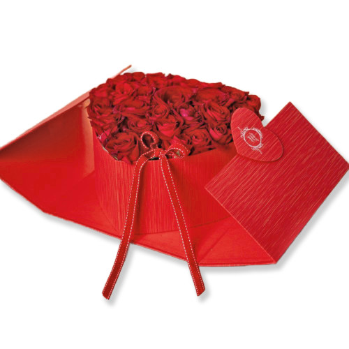 Red heart shaped box filled with flowers