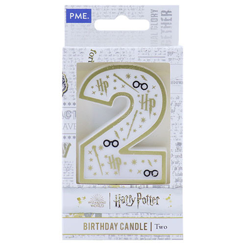 A white, gold, and black number two candle with Harry Potter themed design, shown within boxed packaging.