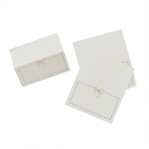 A pack of 8 White & Gold Wavy Edge Bow Place Cards, manufactured by Hootyballoo.