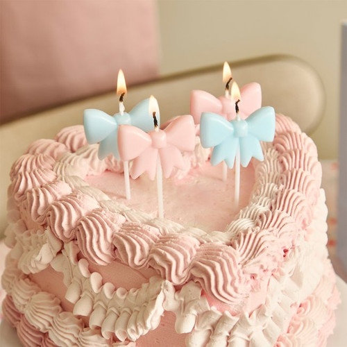 A pack of 4 Pastel Pink & Blue Bow Candles.