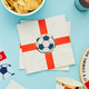 A pack of England printed napkins, white with reg flag and fooball shape print, manufactured by Hootyballoo.