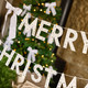 A White Merry Christmas Card Banner with Velvet Bows.