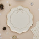 A pack of 8 White & Gold Wavy Edge Bow Paper Plates.