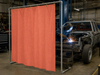 17 oz. Salmon Neoprene Coated Fiberglass Welding Blanket - In Use as Vertical Welding Curtain in Automotive Shop