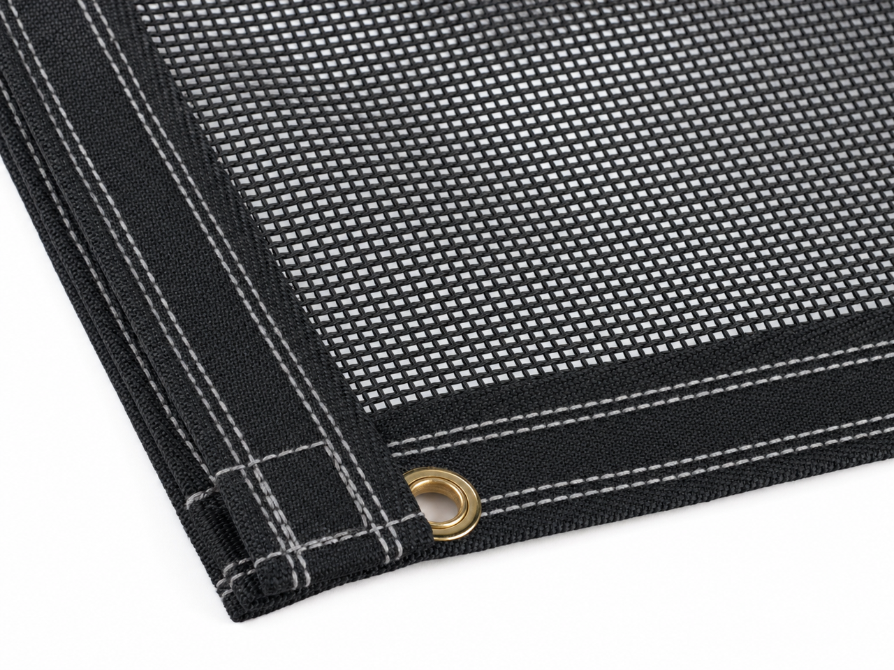 Donovan OX K-PAC Quick Flip 8x28 Mega Mesh Tarp close-up detail showing PVC-coated mesh weave and reinforced double-stitched hem with brass grommet