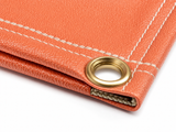 17 oz. Salmon Neoprene Coated Fiberglass Welding Blanket - Close-Up of Neoprene Coating Texture and Brass Grommet