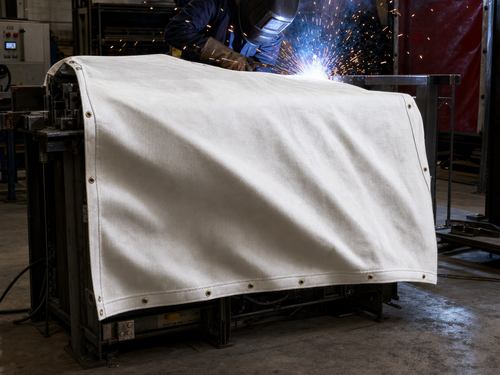 White Fiberglass Welding Blanket in use - protecting equipment from weld spatter