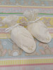 A pretty pair of bootees, Sized to fit 3-6 months, Made in Rice coloured imperial batiste, Wash at 30 degrees, pleated at the back with smocked ribbon insert, Embroidered roses on the toes