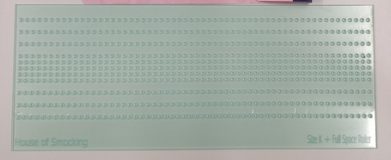 Smocking Dot Ruler by House of Smocking, Use with the water erasable pen or a marker of your choice, Mark off the dots onto the back of your fabric, Size K (half spaces) and Full spaces, Re-position the ruler across your fabric for wider fabrics, Ideal for use on white fabrics as iron on dots don't always wash off, Ideal for dolls clothes and small craft projects, Spaces are 0.5 cm x 0.5 cm and 0.5 cm x 1 cm Size 'K' and pleater compatible
Use to mark dots from a wavy line, Turn the ruler round and use for longer rows without re-positioning the ruler, Use for marking dots up to armholes, add rows by lining the holes up with the gaps between the threads  Lots of possibilities, Can also be used for chicken scratch to mark the squares 