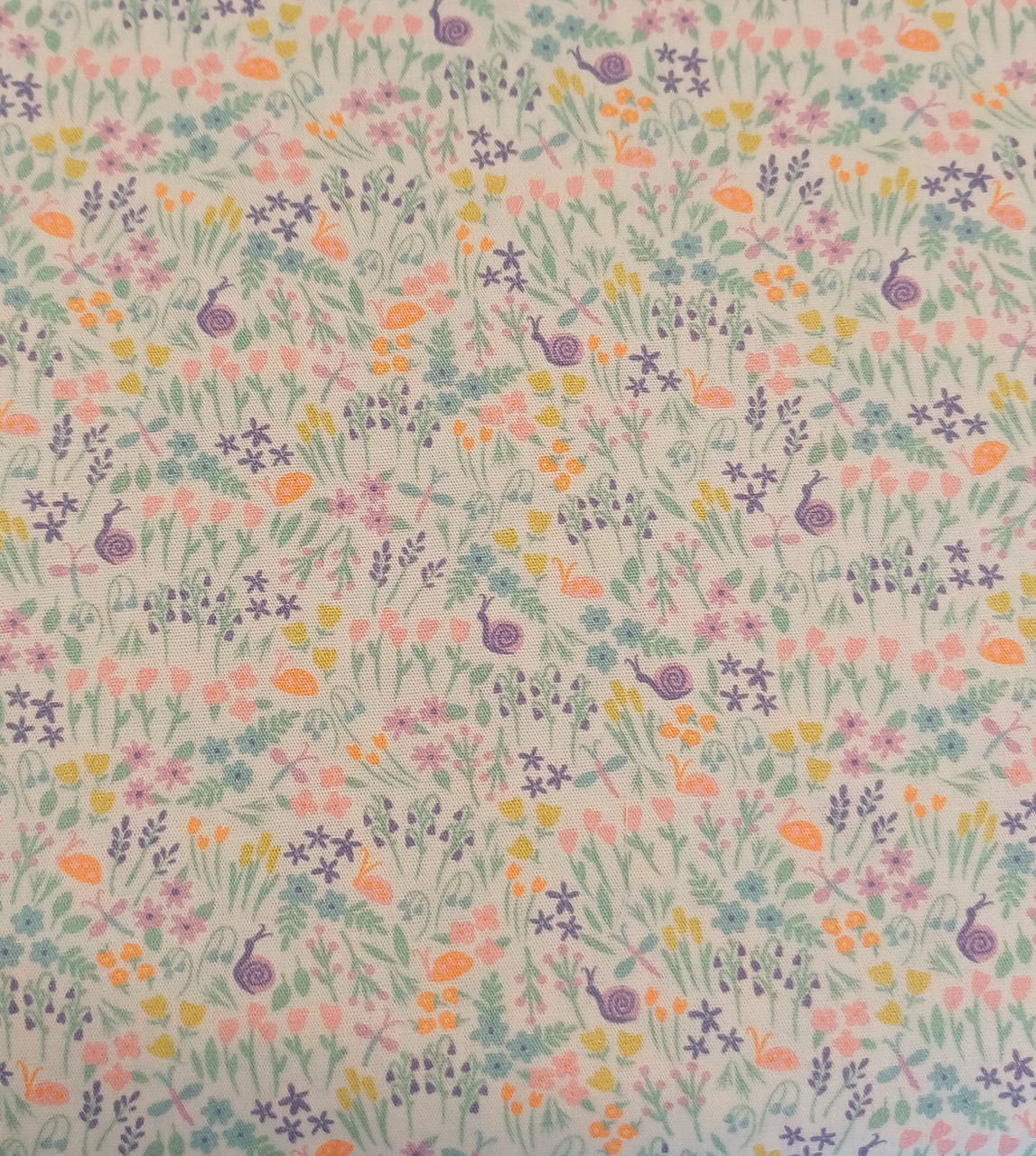 A really pretty floral print fabric, With snails and Dragonflies, 100% cotton, 150 cm (60" wide), Priced per metre, Wash at 30 degrees, 
This fabric has aqua, purple, yellow, and orange flowers, snails, and dragonflies on a solid white background, Will be perfect for your next dress or other outfits.