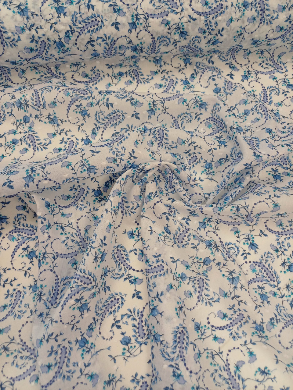 A really pretty floral print cotton, Almost a paisley design in blue and white, 100% cotton, 140 cm wide, Wash at 30 degrees, Ideal for shirts, dresses and more, Priced per metre 