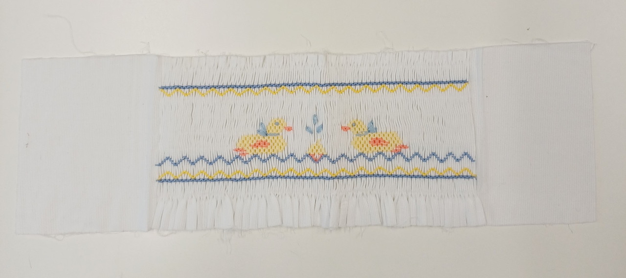 Ready smocked insert on white pique, Picture smocked ducks on water, Total length 35.5 cm 14 inches, Smocked length 20cm or 7 3/4 inches, Width top to bottom 11 cm or 4 1/4 inches, Fabric is 100% cotton