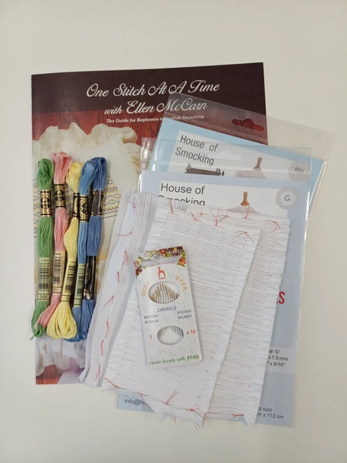 This beginners kit includes everything you need to get started with smocking, 
The One stitch booklet explains, How to use the thread, How to make the stitches , Includes, Several smocking designs, Some smocking projects - cushion, collar, eyelet collar, Also included, Pre-pleated fabric 16 rows, Five DMC stranded cotton threads for the cushion project, pack of crewel needles, Two sheets smocking dots and two pleated pieces for practising the stitches