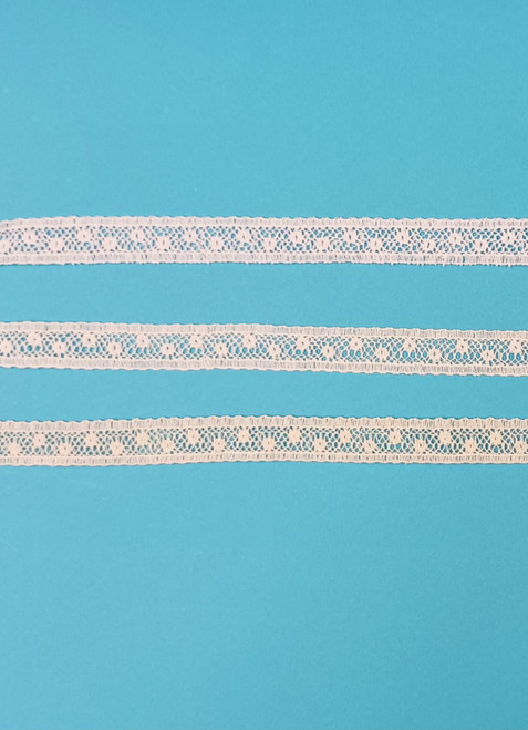 A narrow insertion lace, ideal for using to attach to ribbon hole lace, beading or edging lace or straight to fabric, a very useful simple pattern which goes well with other laces, 
1 cm wide, 95% cotton 5% nylon, Available in White, Off White and Ecru, Priced per metre