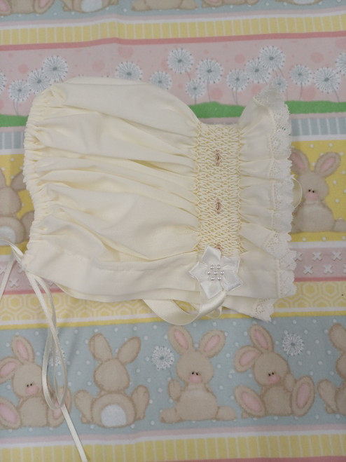A pretty smocked bonnet, Sized to fit 3-6 months, Made in Rice coloured imperial batiste, Wash at 30 degrees, Draw string at the back for size adjustment,