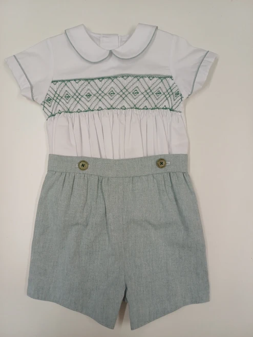 A lovely little button on suit, Size 12-18 month, Green and white coloured hand smocking, Forest Green coloured piping, Forest green coloured button on pants, Elastic back waistband, Elasticated round the back of the legs, Shirt made from 100% cotton poplin, Pants made from 100% sun-washed chambray, Wash at 30 degrees