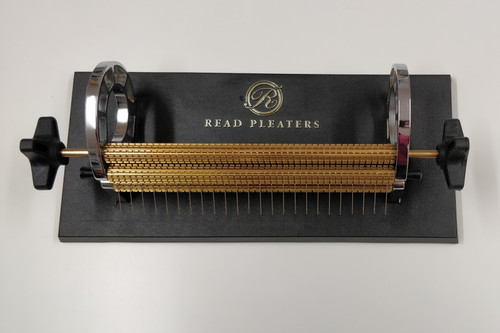 Current Model Read Pleater,
Read 24 row Maxi Pleater has half cm spacing across the entire width of the roller (47 needles).  
Half spaces can be used as guide lines when smocking and to improve holding difficult fabrics which tend to bubble.
The Maxi can also be used as a Regular pleater (24 needles) by removing the half space needles (every second needle).
This pleater has the following specifications
Heavy duty stable base-plate with anti-skid rubber feet
Extra large side-plate opening allowing for large capacity of rolled-up fabric
Simple, pin-type roller holding system allows for quick and easy needle access
Comfortable and user-friendly dual handles for maximum versatility
Heavy-solid brass rollers
Capable of handling heavy-weight fabrics
Comes complete with Original Read Needles
My personal opinion
This is a great machine and will cope with most pleating tasks
The two handles gives that extra grip with thicker fabric or if you are left handed
Plus points - Very easy to remove the roller to change the needles,
Full length half space rows so if you are smocking shoulder to waist or use silk fabrics or prefer more guide rows, then this is the machine for you
Minus points - non really just a shame the base is that bit larger to sit directly on the Feeder box like the Princess Pleater
Can be used with the Pleater Feeder using the adapter lid
Adapter lid supplied free when buying a pleater and feeder