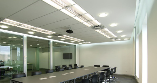 ATDEC TH-WH-PJ-FM universal projector mount installed in conference room with long table and chairs.