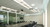 ATDEC TH-WH-PJ-FM universal projector mount installed in conference room with long table and chairs.