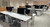 Two Ora with F-clamp and a laptop tray in white in a commercial workspace