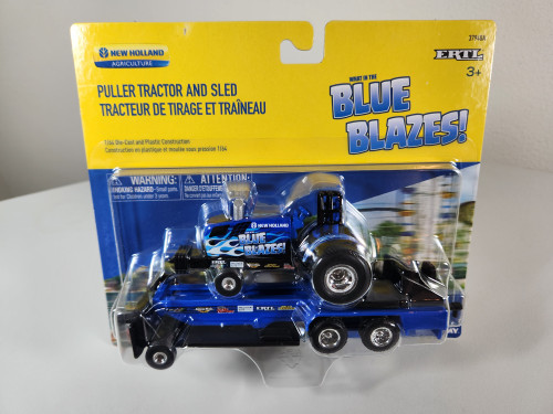 1:64 New Holland What In The Blue Blazes! Puller Tractor with Blue Sled by Ertl