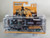 1:64 Hollywood Hitch & Tow Series 11 - Yellowstone (2018-Current TV Series) - 2018 Ford F-150 Montana Livestock Association with 1992 Ford Bronco Montana Livestock Association on Flatbed Trailer Green Machine