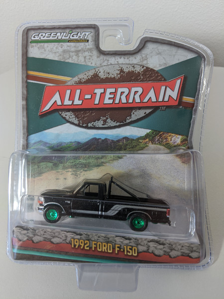 1:64 All-Terrain Series 9 - 1992 Ford F-150 4x4 - Raven Black with Silver Stripes Green Machine