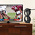 Lifestyle image of the ClearStream 2MAX TV antenna with mast inside on TV stand next to TV