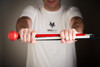 Introducing the All Terrain Cane by Awarewolf Gear. Strength, Outdoorsmanship, Empowerment, Freedom, Confidence, and ultimate mobility. Man holding the All Terrain Cane with two hands with the cane folded. All Terrain Cane logo featured on front. Cane photographed with Red roller ball tip.