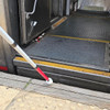 Urban Xplorer mobility cane fully extended and positioned on a railway platform getting ready to traverse the yellow tactile concrete while proceeding to the rail car with a large gap between the platform and train.