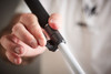 Person gripping the flip lock section of the Urban Xplorer mobility cane getting ready to secure adjusted length. Adjustable cane height.
