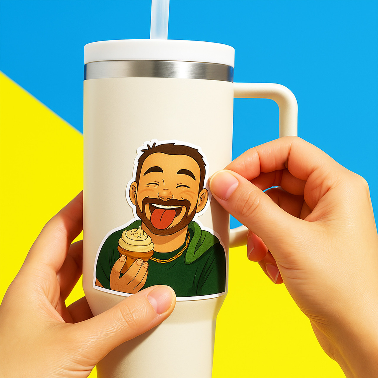 Sticker of a smiling cartoon man with a beard, sticking out his tongue while holding a cupcake, being applied to a white tumbler against a bright yellow and blue background.