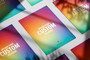 A grid layout of multiple custom printed posters showcasing a rainbow gradient image with the text "Upload Your Custom Artwork" laying on the ground