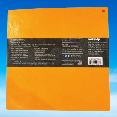 Backside of Soda Pup Zombie eMat enrichment mat in orange, sharing benefits, usage instructions, and materials information, and prominently displaying the 'Made in the USA' label.