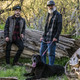 Photo of black dog laying wearing Wolfgang DigitalDog Dog Collar with leash with two men.