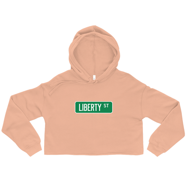A mockup of the Liberty St Street Sign Mucnie Ladies Cropped Hoodie
