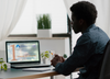 A man watching the course on a laptop